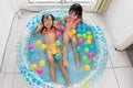 Happy Asian Chinese little sisters playing in the inflatable poo Royalty Free Stock Photo