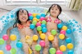 Happy Asian Chinese little sisters playing in the inflatable poo Royalty Free Stock Photo