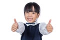 Happy Asian Chinese little student girl showing thumbs up