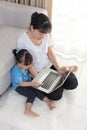 Happy Asian Chinese mother and daughter using laptop at home Royalty Free Stock Photo