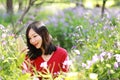 Happy Asian Chinese woman beauty girl smile in a flower field in a spring summer autumn park selfie Royalty Free Stock Photo