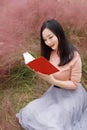 Happy Asian Chinese woman girl feel freedom sweet dream pray flower field autumn fall park grass lawn hope nature read book school