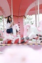 Happy Asian Chinese woman girl on Merry-go-round in a Amusement Park Royalty Free Stock Photo