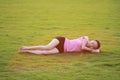 Happy Asian Chinese woman have a rest on grass Royalty Free Stock Photo