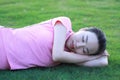 Happy Asian Chinese woman relax on grass Royalty Free Stock Photo