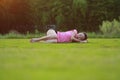 Happy Asian Chinese woman relax on grass Royalty Free Stock Photo