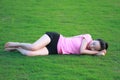 Happy Asian Chinese woman sleep on grass Royalty Free Stock Photo