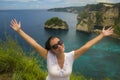 Happy Asian Chinese woman in sunglasses enjoying amazing coast scene from view point at tropical paradise beach with diamond rock Royalty Free Stock Photo