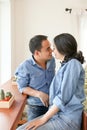 Happy Asian couple in blue jean dress in a coffee shop Royalty Free Stock Photo