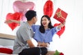 Happy Asian couple celebrate anniversary together, boyfriend give present gift box to surprised girlfriend who need hug him, Royalty Free Stock Photo