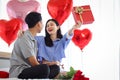 Happy Asian couple celebrate anniversary together, boyfriend give present gift box to surprised girlfriend who need hug him, Royalty Free Stock Photo