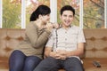 Happy Asian couple on a couch at home Royalty Free Stock Photo