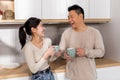 Happy asian couple enjoying morning coffee at home Royalty Free Stock Photo