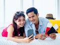 Happy Asian couple with flight booking or shopping online for summer trip, travel abroad. Royalty Free Stock Photo