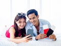 Happy Asian couple with flight booking or shopping online for summer trip, travel abroad. Royalty Free Stock Photo