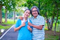 They are happy Asian couple.They give a big hug together after Jogging in park. Royalty Free Stock Photo