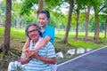 They are happy Asian couple.They give a big hug together after Jogging in park.