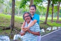 They are happy Asian couple.They give a big hug together after Jogging in park. Royalty Free Stock Photo