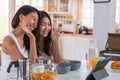 Happy asian couple lesbian getting marriage and showing ring to friend infront of tablet with video call.LGBTQ lifestyle concept