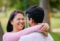 Happy Asian couple looking in love while standing face to face in a park. Happy romantic moments of lovely couple Royalty Free Stock Photo