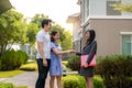 Happy Asian couple looking for their new house and shake hands with real estate broker after a deal. Young couple handshaking real Royalty Free Stock Photo