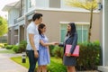 Happy Asian couple looking for their new house and shake hands with real estate broker after a deal. Young couple handshaking real Royalty Free Stock Photo