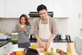 Happy asian couple in love in kitchen making healthy juice Royalty Free Stock Photo