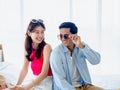 Happy Asian couple lover in summer, young man and woman wearing sunglasses with fun smile. Royalty Free Stock Photo