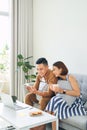 Happy Asian couple lover using mobile, laptop together at home Royalty Free Stock Photo