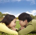 Happy asian couple lying on the grass Royalty Free Stock Photo