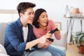 Happy Asian Couple Playing Videogame Having Fun On Weekend Indoor Royalty Free Stock Photo