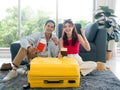 Happy Asian couple ready to trip, young man and woman smile and raising fist. Royalty Free Stock Photo