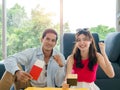 Happy Asian couple ready to trip, young man and woman smile and raising fist and hold and show passport together. Royalty Free Stock Photo