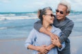 Happy asian couple senior eldely retirement resting at beach honeymoon family together Royalty Free Stock Photo