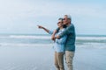 Happy asian couple senior elderly retirement resting at beach honeymoon Royalty Free Stock Photo