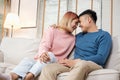 Happy asian couple sitting on sofa after unpacking cardboard boxes  while moving to new home at sofa in living room.new house Royalty Free Stock Photo