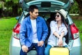 Happy Asian couple traveling and sitting in a car Royalty Free Stock Photo