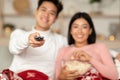 Happy Asian Couple Watching TV Enjoying Christmas Movies At Home Royalty Free Stock Photo