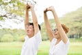 Happy Asian couple in white shirt workout at the park. Royalty Free Stock Photo