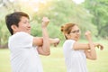 Happy Asian couple in white shirt workout at the park. Royalty Free Stock Photo