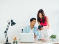 Happy Asian couple, young man and woman using tablet and laptop computer together. Royalty Free Stock Photo