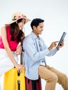 Happy Asian couple, young woman with beach hat and man in denim shirt sit on suitcase. Royalty Free Stock Photo