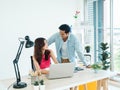 Happy Asian couple, young woman and man using tablet and laptop computer. Royalty Free Stock Photo