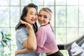 Happy Asian daughter and elderly mother in sportswear exercise together at home both of them smiled happily. Retired woman enjoy Royalty Free Stock Photo
