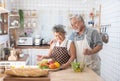 Happy asian elder senior couple cooking fresh meal in kitchen at home Royalty Free Stock Photo