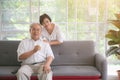 Happy asian elderly couple in love drinking milk togetherness at the living room. Healthy food concept Royalty Free Stock Photo