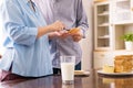 Happy asian elderly couple preparing healthy food for breakfast with bread and butter,Retirement senior lifestyle living concept,C Royalty Free Stock Photo