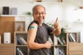 Happy Asian Elderly man received anti virus vaccine cheerful thumbs up with bandage,Senior handsome enjoying and confident with