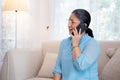 Happy asian elderly woman sitting on sofa with cozy talking with smartphone in living room at home. Royalty Free Stock Photo