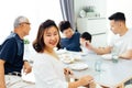 Happy Asian extended family having dinner at home full of happiness and smiles. Royalty Free Stock Photo